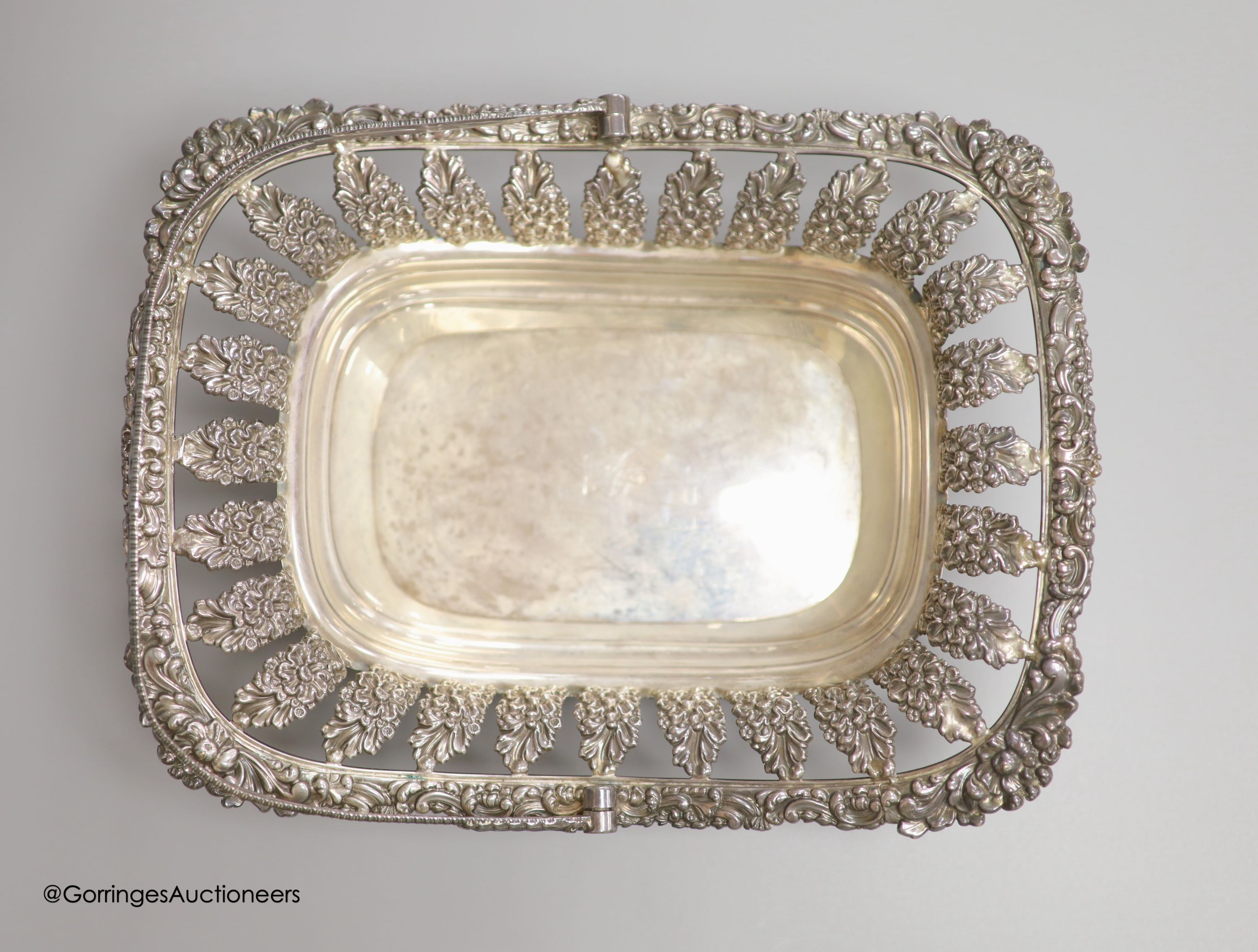 A George III silver swing-handled cake basket with cast and embossed foliate decoration, 28.83oz